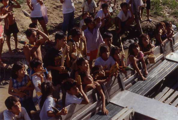 villagers crowding a boat photo